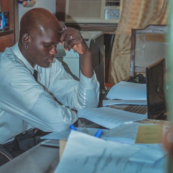 An office worker at a desk transforms into a serene yoga practitioner.